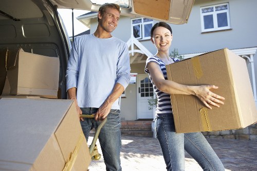 Professional man and van crew handling boxes and household items in Hanwell